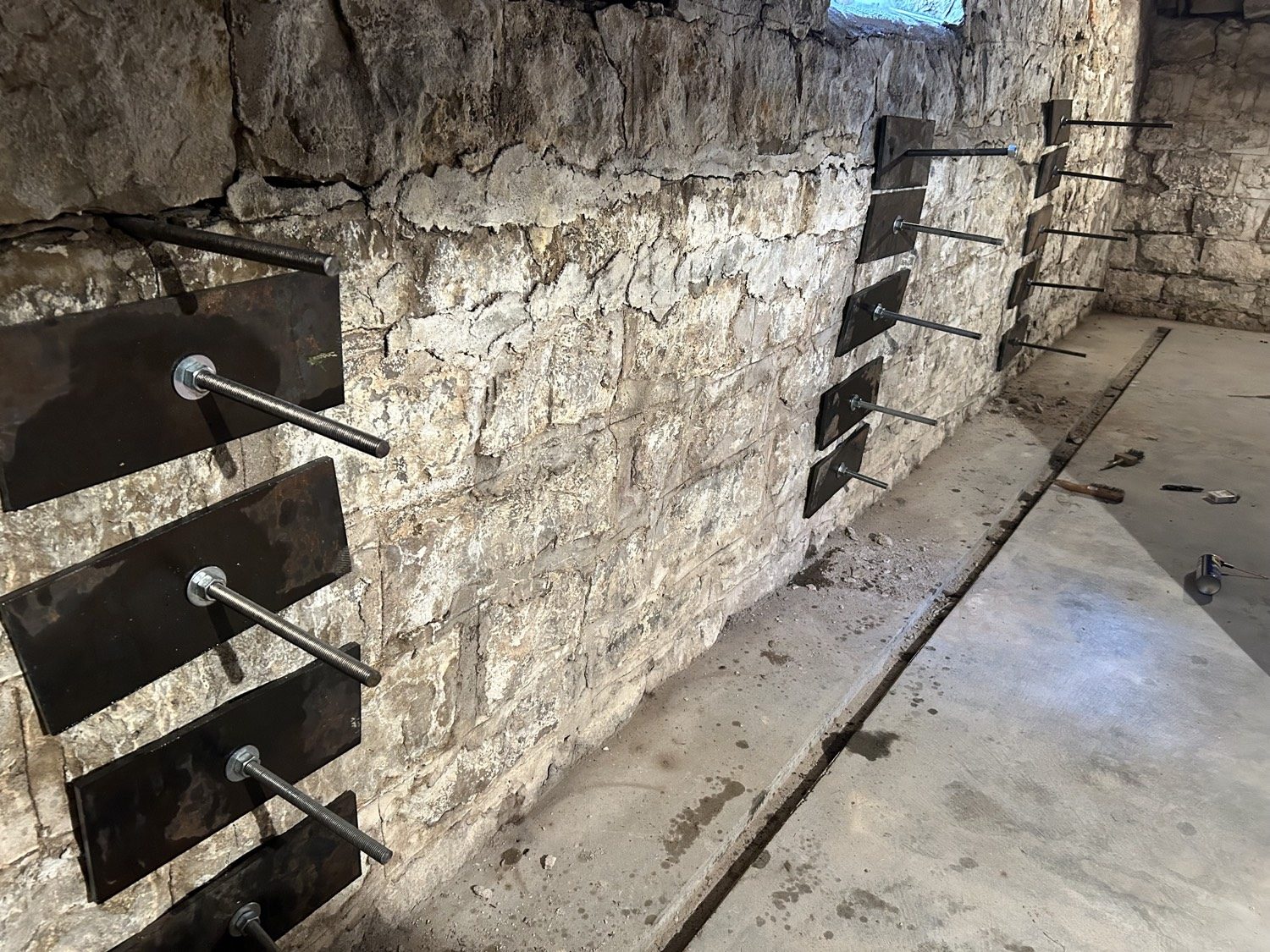 The same stone foundation from the other end, plates and all-thread in place