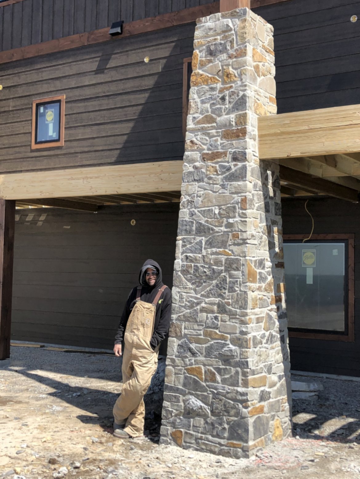 Josh Link standing beside a tapered full-depth stone column