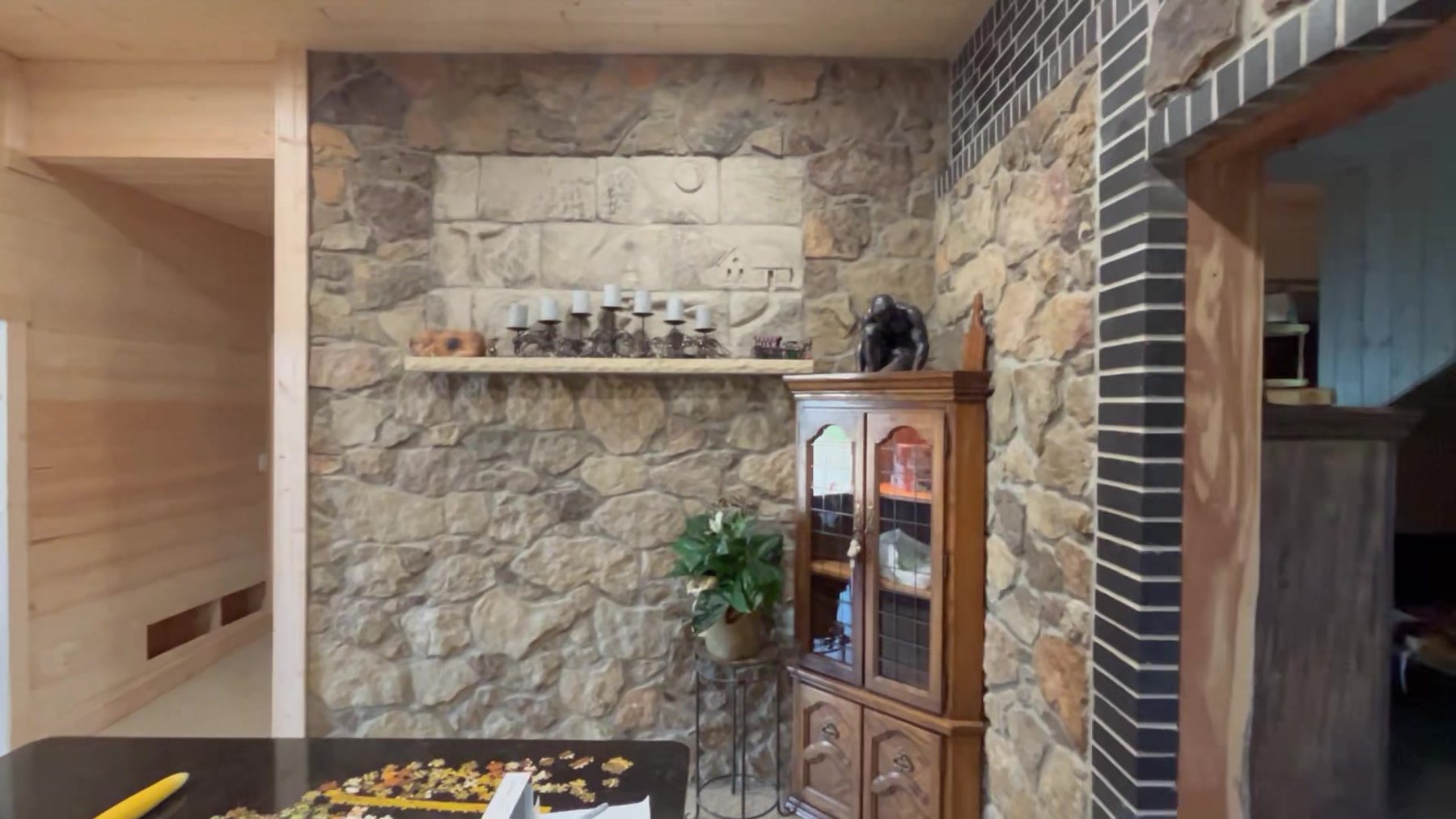 The carved Kansas limestone relief set into the sandstone kitchen wall above a stone shelf
